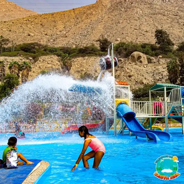 Balde gigante volcando agua sobre el tobogán